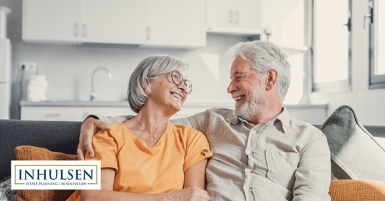 older couple smiling at each other on the couch